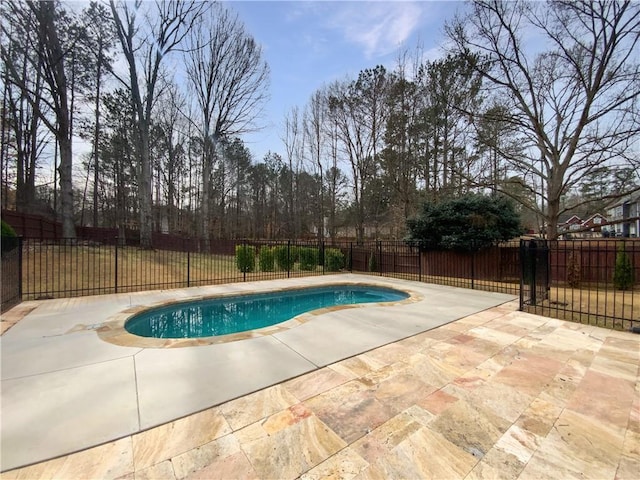 view of swimming pool with a fenced backyard, a fenced in pool, and a patio