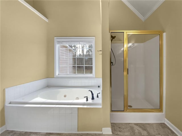 bathroom featuring lofted ceiling, a stall shower, a jetted tub, and crown molding