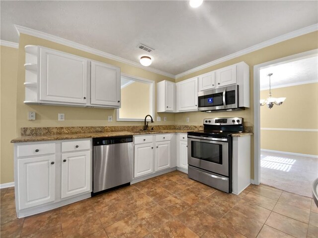 kitchen with visible vents, white cabinets, appliances with stainless steel finishes, ornamental molding, and a sink