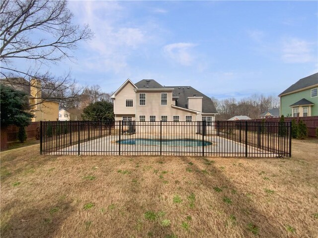 view of pool featuring a fenced in pool, a fenced backyard, a patio, and a lawn