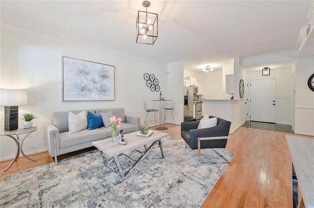 living room with hardwood / wood-style floors and ornamental molding