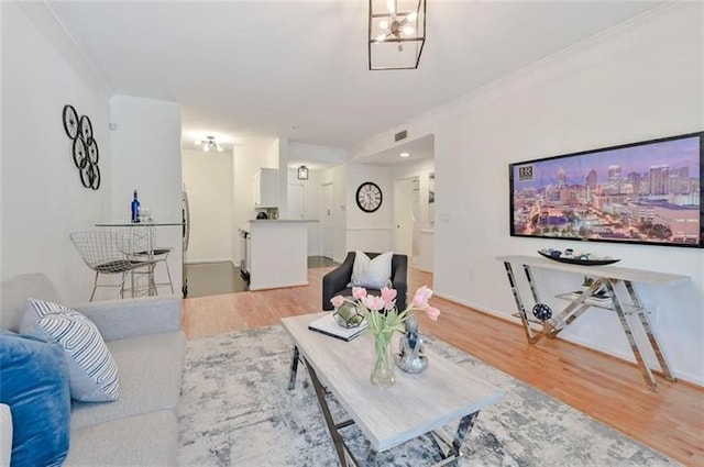 living room with crown molding and hardwood / wood-style flooring