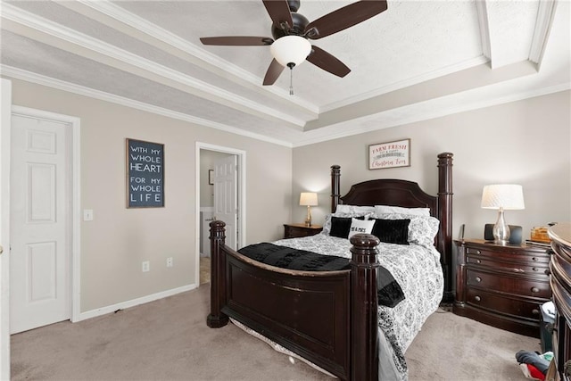 bedroom featuring a tray ceiling, light carpet, baseboards, and crown molding