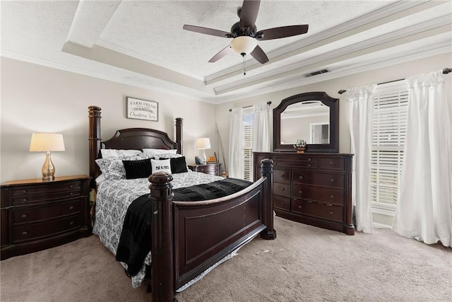 carpeted bedroom featuring a raised ceiling, crown molding, visible vents, and a textured ceiling