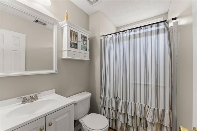 bathroom with visible vents, curtained shower, toilet, and vanity