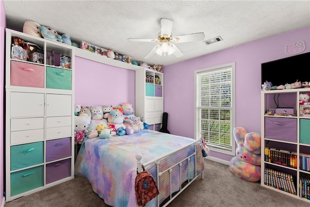 bedroom with visible vents, carpet flooring, a textured ceiling, and ceiling fan