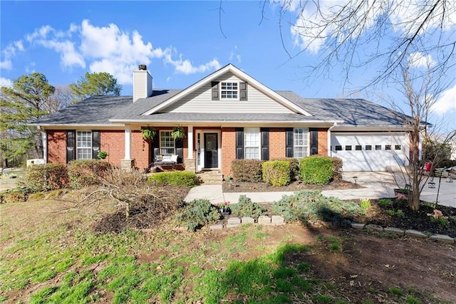 view of front of home with brick siding, a porch, an attached garage, and a chimney