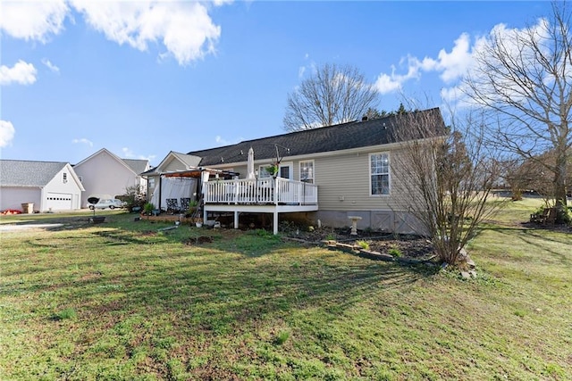 back of house featuring a lawn, a wooden deck, and a garage