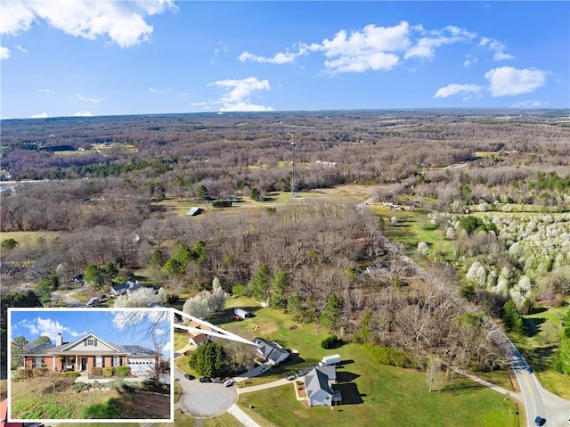 bird's eye view featuring a forest view