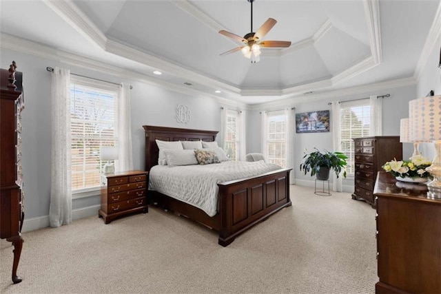 bedroom featuring ornamental molding, a raised ceiling, and baseboards