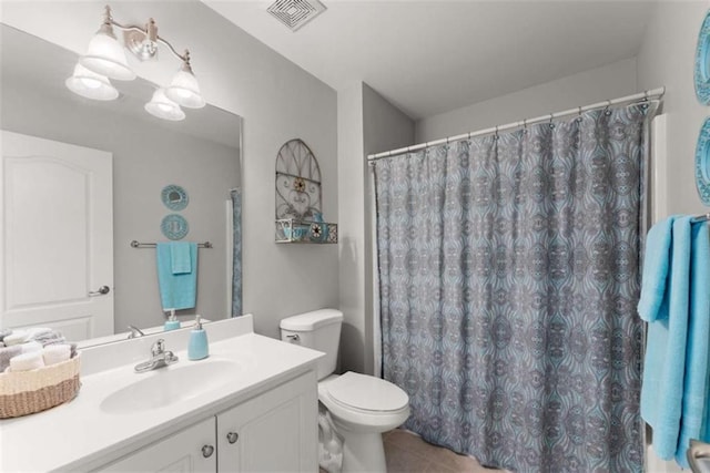 full bath with visible vents, a shower with shower curtain, toilet, tile patterned flooring, and vanity