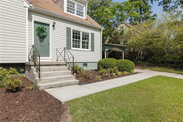 doorway to property with a lawn, crawl space, and a shingled roof