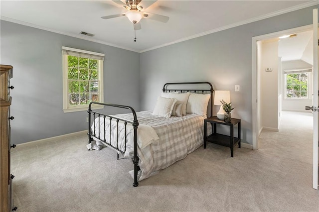 carpeted bedroom with baseboards, multiple windows, ornamental molding, and a ceiling fan