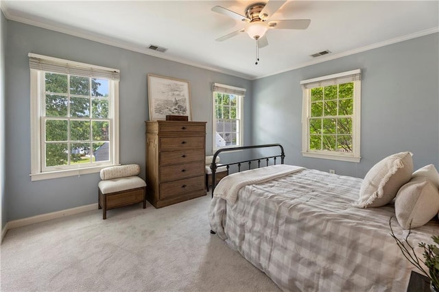 carpeted bedroom with ornamental molding, baseboards, and a ceiling fan