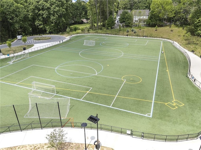 view of home's community featuring an area for soccer and fence