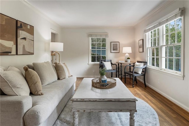 living room featuring baseboards, ornamental molding, and wood finished floors