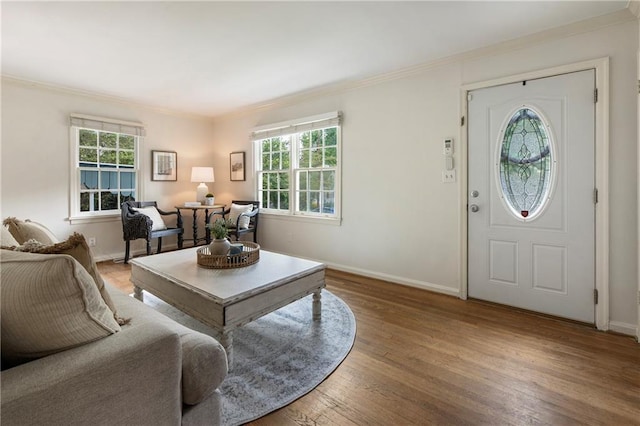 living room featuring crown molding, wood finished floors, and baseboards