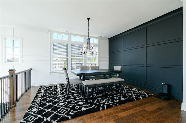 6666 Sterling Dr, Sandy Springs, GA 30328 - dining space with a decorative wall, a chandelier, wood finished floors, healthy amount of natural light, and baseboards