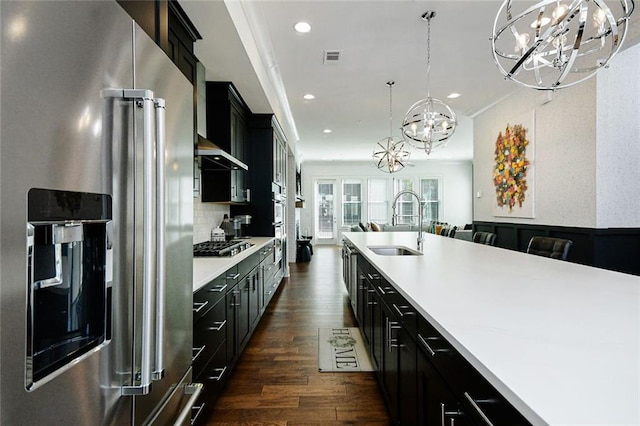 6666 Sterling Dr, Sandy Springs, GA 30328 - kitchen featuring appliances with stainless steel finishes, a chandelier, dark cabinets, a sink, and recessed lighting