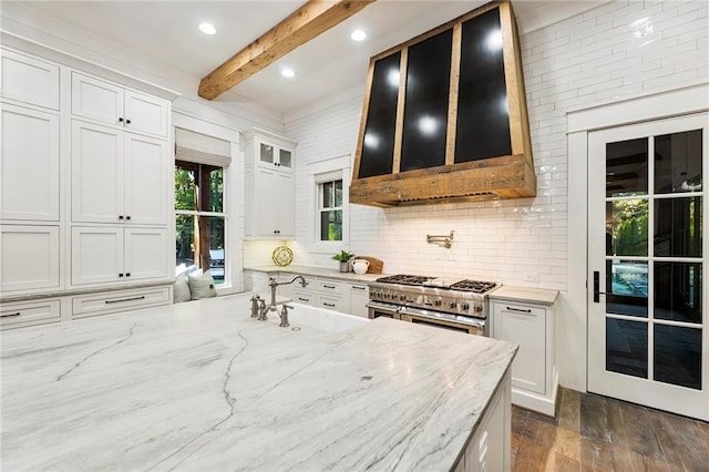 kitchen featuring white cabinetry, light stone countertops, beamed ceiling, and high end stove