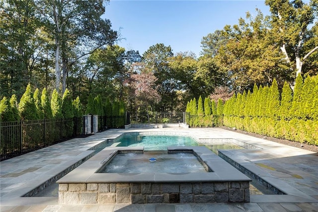 view of pool featuring an in ground hot tub