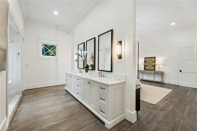 bathroom with vanity, crown molding, hardwood / wood-style floors, and a shower