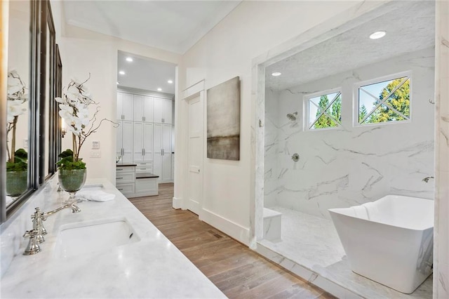 bathroom with vanity, shower with separate bathtub, and hardwood / wood-style flooring