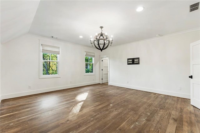 unfurnished room with a notable chandelier, lofted ceiling, dark hardwood / wood-style flooring, and ornamental molding