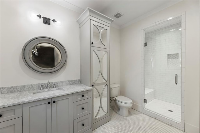 bathroom featuring toilet, an enclosed shower, vanity, and tile patterned floors