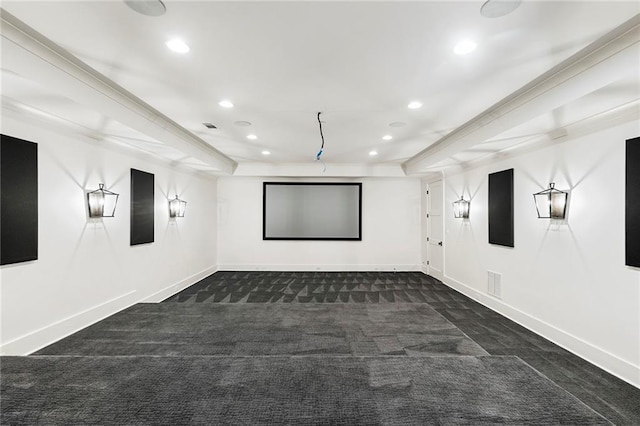 cinema with ornamental molding and dark carpet