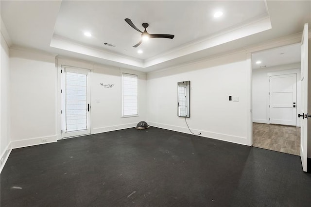 unfurnished room with ceiling fan, a raised ceiling, and ornamental molding