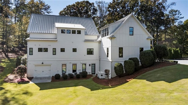 view of front of home with a garage and a front lawn