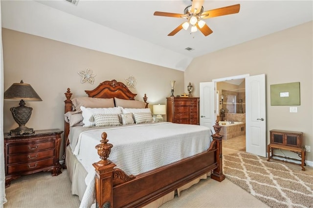 carpeted bedroom featuring connected bathroom, ceiling fan, vaulted ceiling, and visible vents