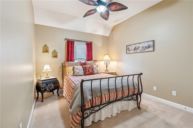 bedroom featuring baseboards, light colored carpet, ceiling fan, and lofted ceiling