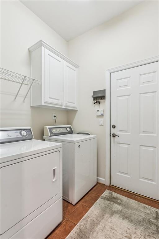 clothes washing area with cabinet space, separate washer and dryer, and tile patterned flooring