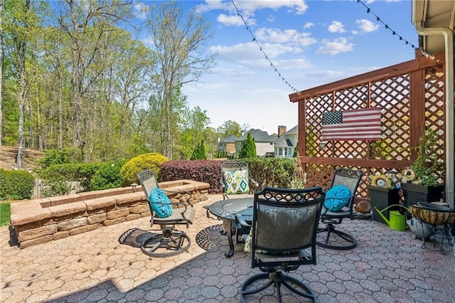 view of patio with a fire pit