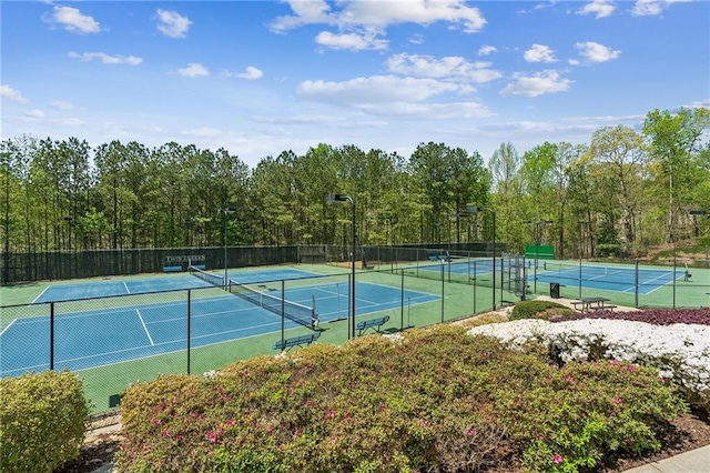view of tennis court featuring fence