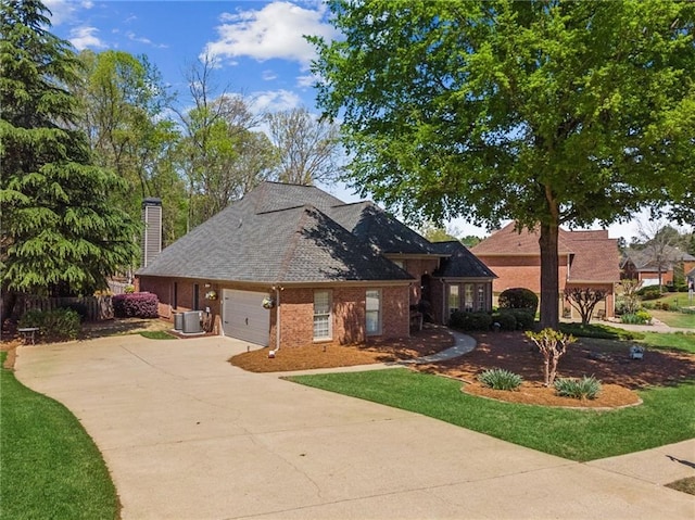 view of front facade featuring driveway, a chimney, a garage, central air condition unit, and brick siding