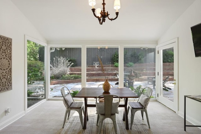 carpeted dining area featuring baseboards, lofted ceiling, and a notable chandelier