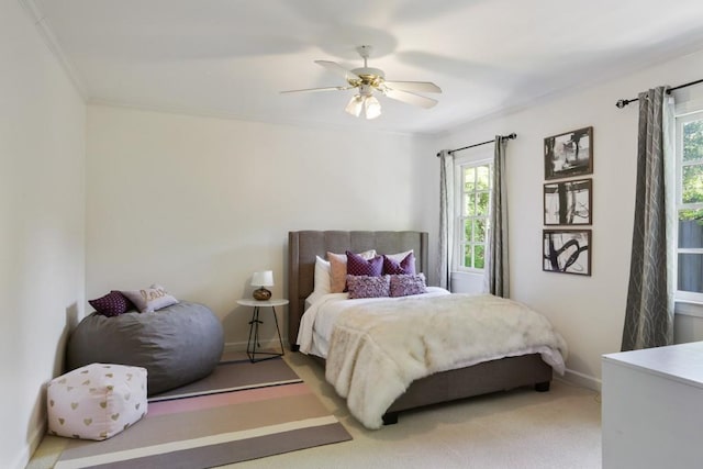 bedroom featuring baseboards, ceiling fan, carpet flooring, and crown molding