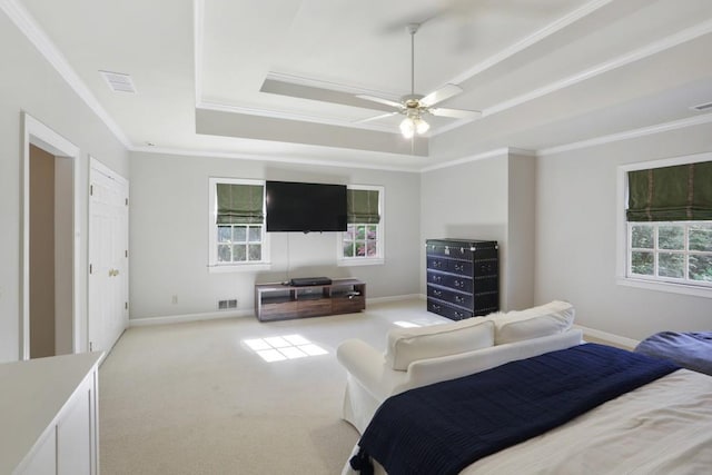 bedroom featuring visible vents, multiple windows, crown molding, and a tray ceiling