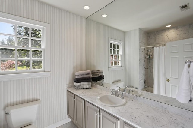 bathroom with visible vents, toilet, recessed lighting, shower / tub combo, and vanity