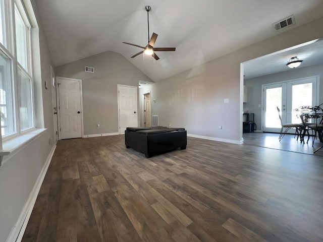 unfurnished living room with french doors, visible vents, dark wood-style flooring, and baseboards