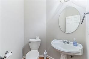 bathroom featuring sink and toilet