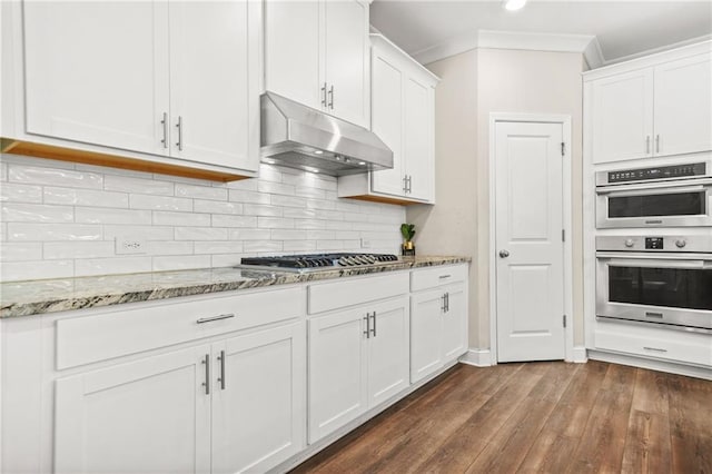 4110 Morgan Elizabeth Way, Cumming, GA 30041 - kitchen featuring under cabinet range hood, appliances with stainless steel finishes, white cabinetry, dark wood-type flooring, and light stone counters