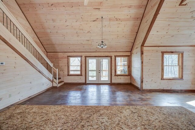 unfurnished living room featuring wood ceiling, a healthy amount of sunlight, and wood finished floors