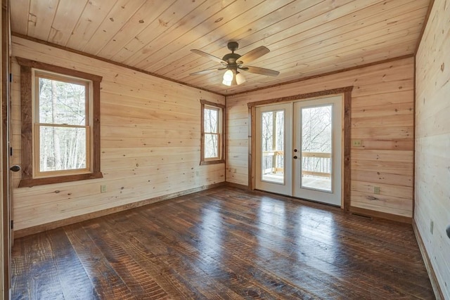 spare room with wooden walls, french doors, wooden ceiling, and dark wood-style floors