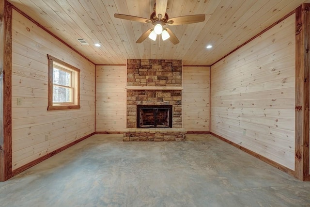 unfurnished living room featuring concrete floors, ceiling fan, a fireplace, wood ceiling, and wood walls