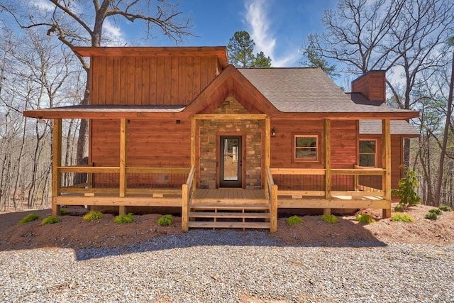 exterior space featuring a porch and a chimney