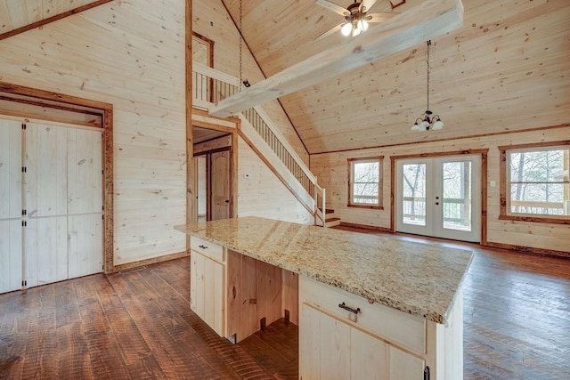 additional living space with high vaulted ceiling, ceiling fan, wood ceiling, dark wood-style flooring, and wooden walls